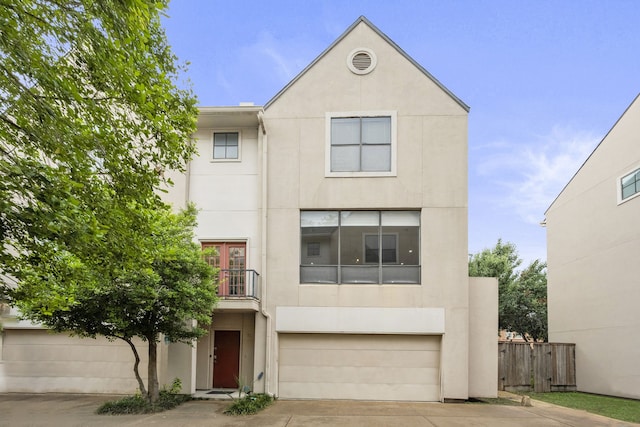 939 Colorado St Unit 22, Houston, TX 77007 - townhome / multi-family property featuring stucco siding, concrete driveway, an attached garage, and a balcony