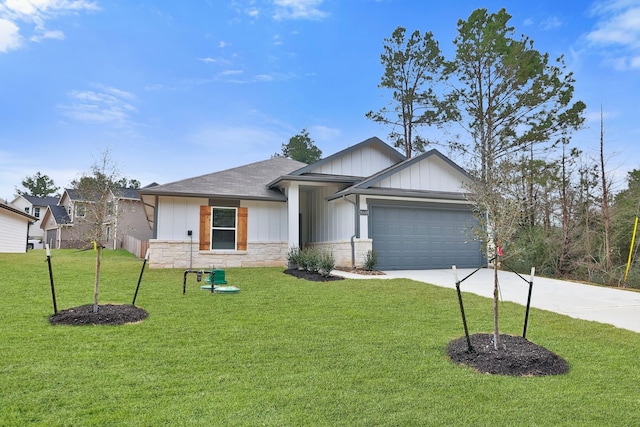 26449 Lakeshore Dr, Hempstead, TX 77445 - view of front facade featuring board and batten siding, concrete driveway, an attached garage, a front yard, and stone siding