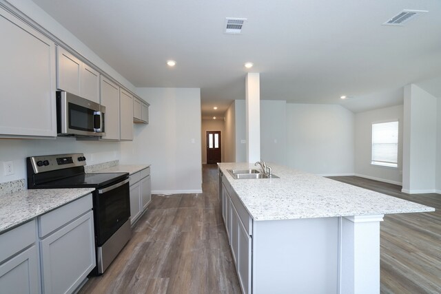 26449 Lakeshore Dr, Hempstead, TX 77445 - kitchen with stainless steel appliances, gray cabinetry, dark wood-type flooring, a sink, and baseboards