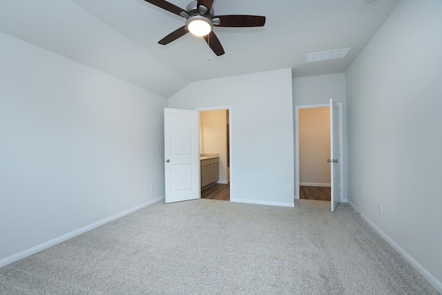 26449 Lakeshore Dr, Hempstead, TX 77445 - unfurnished bedroom with carpet floors, baseboards, lofted ceiling, ensuite bath, and a ceiling fan
