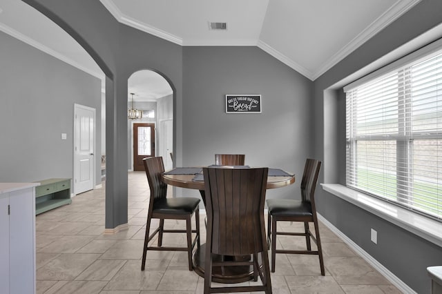 3921 Enchanted Timbers Ln, Spring, TX 77386 - dining space with arched walkways, vaulted ceiling, a chandelier, crown molding, and baseboards