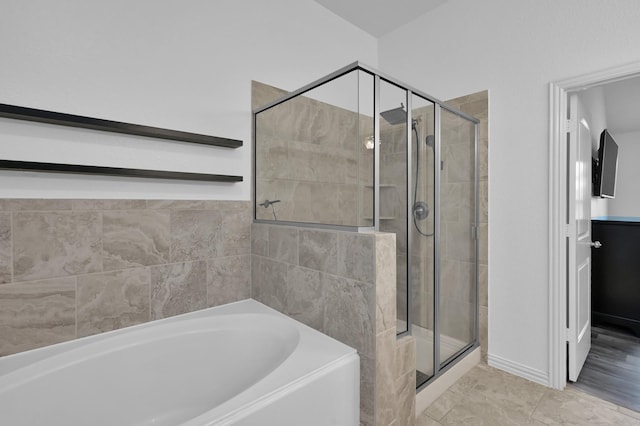 3921 Enchanted Timbers Ln, Spring, TX 77386 - full bathroom featuring a stall shower and a bath