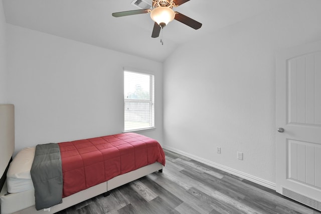 3921 Enchanted Timbers Ln, Spring, TX 77386 - bedroom featuring wood finished floors, lofted ceiling, baseboards, and a ceiling fan