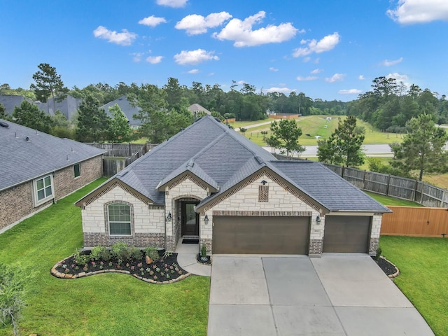 3921 Enchanted Timbers Ln, Spring, TX 77386 - french provincial home with brick siding, a garage, driveway, and roof with shingles