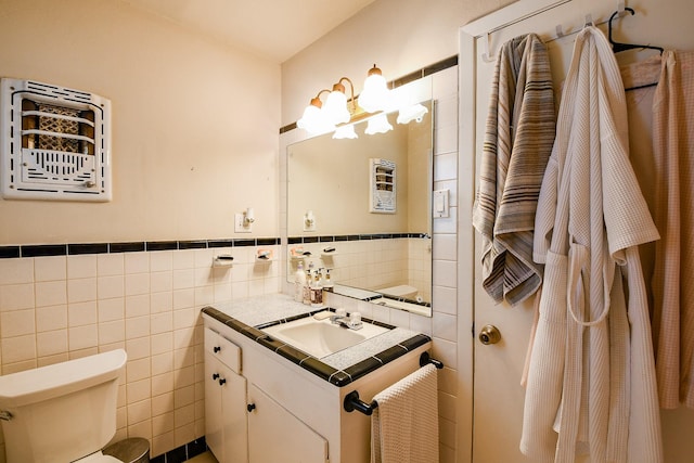 5423 Willow Creek Way, Houston, TX 77017 - bathroom with tile walls, vanity, a chandelier, toilet, and a wainscoted wall