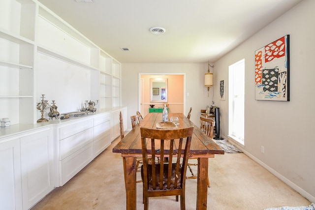 5423 Willow Creek Way, Houston, TX 77017 - dining area with light carpet, baseboards, and built in features