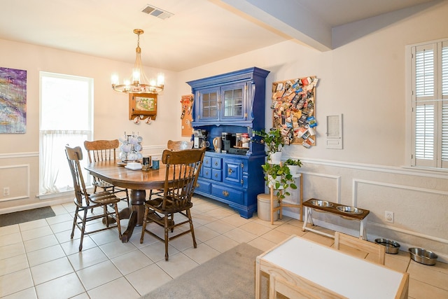 5423 Willow Creek Way, Houston, TX 77017 - dining space featuring a chandelier, healthy amount of natural light, wainscoting, a decorative wall, and light tile patterned floors