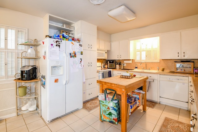 5423 Willow Creek Way, Houston, TX 77017 - kitchen with white appliances, a sink, white cabinets, tasteful backsplash, and light countertops