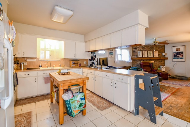 5423 Willow Creek Way, Houston, TX 77017 - kitchen featuring a peninsula, light countertops, freestanding refrigerator, and a ceiling fan