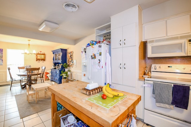 5423 Willow Creek Way, Houston, TX 77017 - kitchen with white appliances, white cabinetry, light tile patterned flooring, a chandelier, and hanging light fixtures