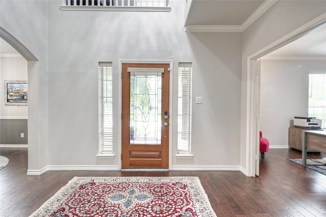 8507 Marchelle Ln, Spring, TX 77379 - foyer with wood finished floors, ornamental molding, arched walkways, and baseboards