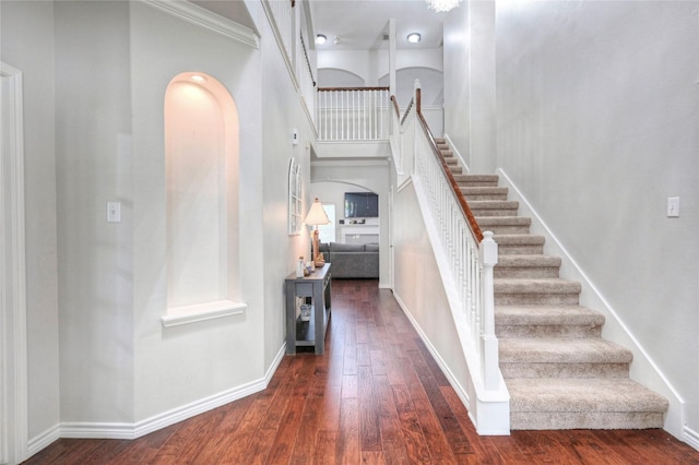 8507 Marchelle Ln, Spring, TX 77379 - stairway featuring arched walkways, wood finished floors, and baseboards