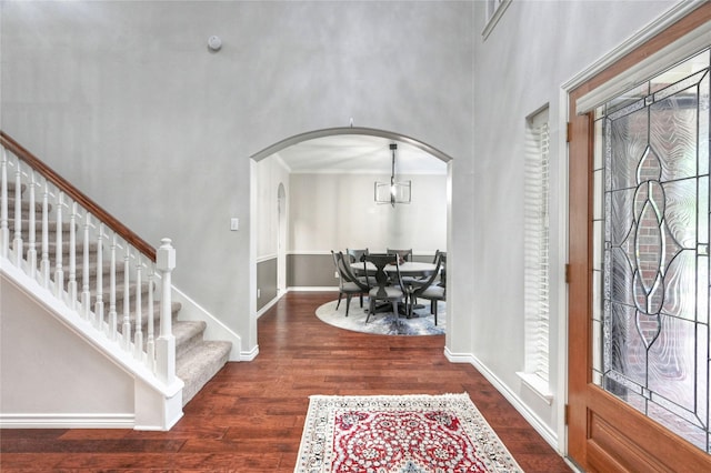8507 Marchelle Ln, Spring, TX 77379 - foyer entrance with arched walkways, wood finished floors, stairway, crown molding, and a towering ceiling