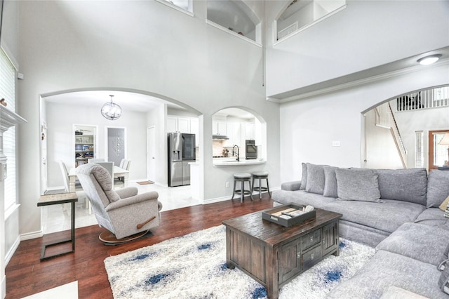 8507 Marchelle Ln, Spring, TX 77379 - living area with wood finished floors, a high ceiling, arched walkways, and plenty of natural light