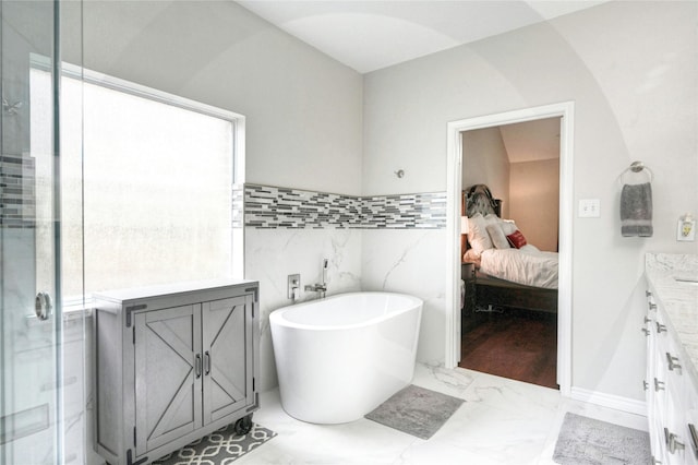 8507 Marchelle Ln, Spring, TX 77379 - full bath with vanity, marble look tile flooring, a soaking tub, tile walls, and a stall shower