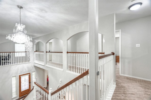 8507 Marchelle Ln, Spring, TX 77379 - hall featuring an upstairs landing, a chandelier, carpet floors, and baseboards