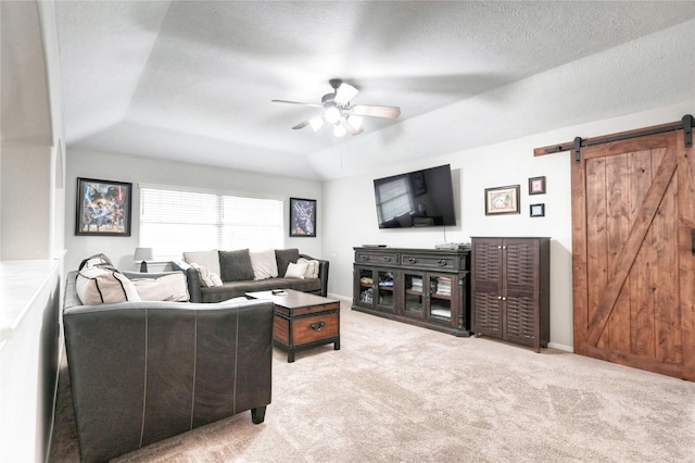 8507 Marchelle Ln, Spring, TX 77379 - carpeted living area featuring a barn door, a raised ceiling, ceiling fan, and baseboards