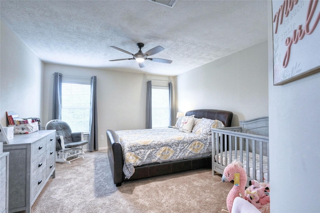 8507 Marchelle Ln, Spring, TX 77379 - bedroom with multiple windows, a textured ceiling, light colored carpet, and ceiling fan