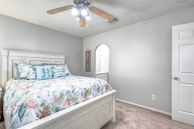 8507 Marchelle Ln, Spring, TX 77379 - bedroom featuring light carpet, arched walkways, baseboards, and ceiling fan