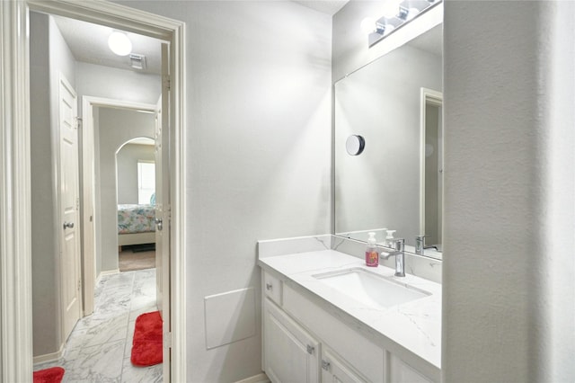 8507 Marchelle Ln, Spring, TX 77379 - bathroom with marble look tiles, vanity, ensuite bath, and baseboards