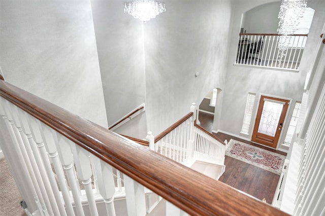 8507 Marchelle Ln, Spring, TX 77379 - entrance foyer with a chandelier, arched walkways, wood finished floors, a towering ceiling, and baseboards
