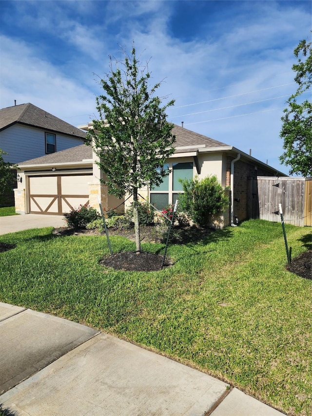 6006 Thief River Falls Dr, Katy, TX 77493 - view of front of house with a garage, a front lawn, driveway, and stucco siding