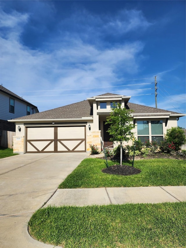 6006 Thief River Falls Dr, Katy, TX 77493 - view of front of property featuring driveway, a garage, stucco siding, roof with shingles, and a front lawn