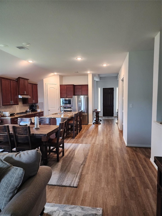 6006 Thief River Falls Dr, Katy, TX 77493 - living room featuring wood finished floors, baseboards, and recessed lighting