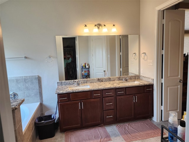 6006 Thief River Falls Dr, Katy, TX 77493 - bathroom featuring double vanity, a garden tub, a walk in closet, and tile patterned flooring