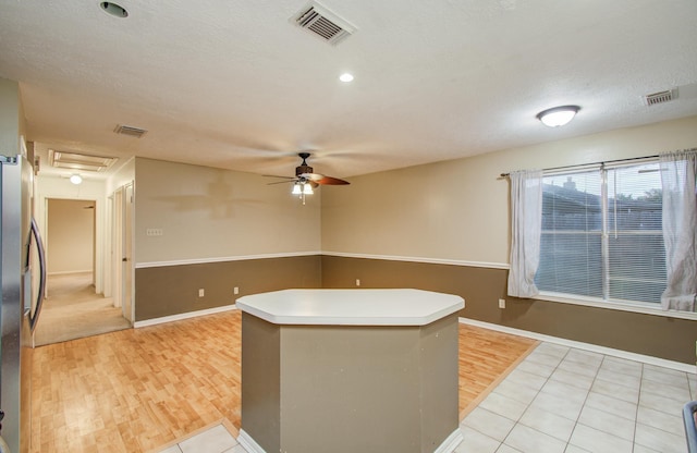 10829 E Linwood Dr, La Porte, TX 77571 - kitchen with a ceiling fan, freestanding refrigerator, light wood-style flooring, a center island, and baseboards