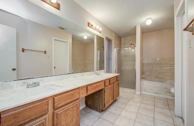 10829 E Linwood Dr, La Porte, TX 77571 - full bathroom with tile patterned flooring, a tile shower, double vanity, a garden tub, and a textured ceiling