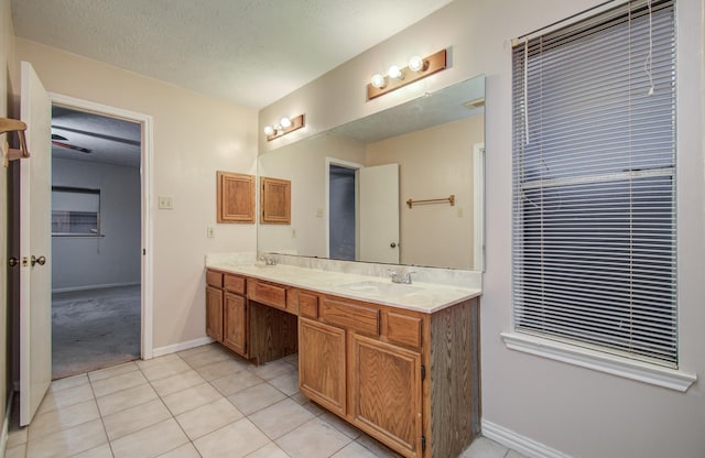 10829 E Linwood Dr, La Porte, TX 77571 - full bath featuring tile patterned floors, double vanity, baseboards, and a textured ceiling