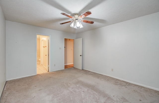 10829 E Linwood Dr, La Porte, TX 77571 - unfurnished bedroom featuring carpet flooring, baseboards, a ceiling fan, and ensuite bathroom