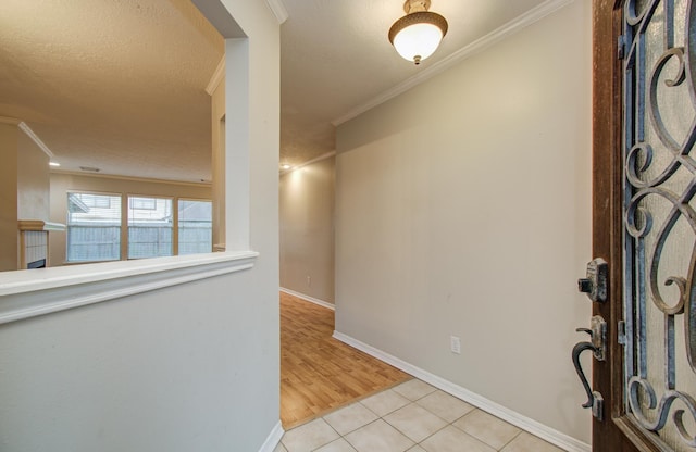 10829 E Linwood Dr, La Porte, TX 77571 - entryway with crown molding, light tile patterned flooring, and baseboards