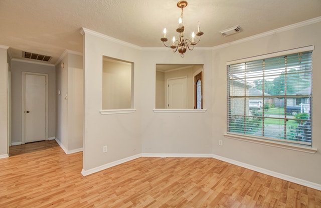 10829 E Linwood Dr, La Porte, TX 77571 - unfurnished room featuring a chandelier, light wood-style flooring, baseboards, ornamental molding, and a textured ceiling