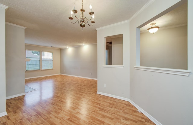 10829 E Linwood Dr, La Porte, TX 77571 - empty room featuring light wood-style flooring, a chandelier, ornamental molding, baseboards, and a textured ceiling