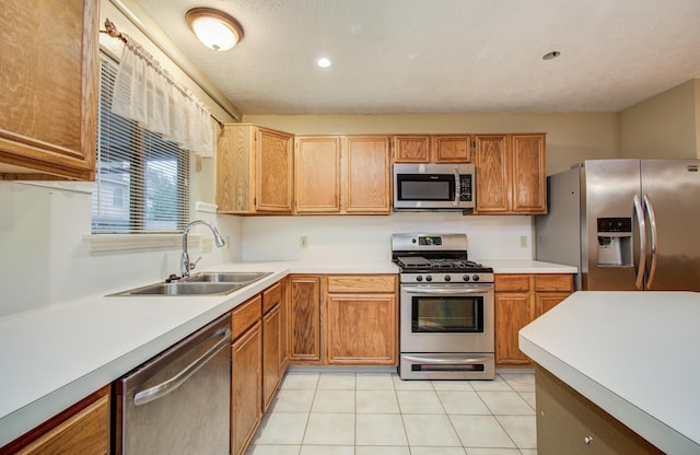 10829 E Linwood Dr, La Porte, TX 77571 - kitchen with stainless steel appliances, a sink, light countertops, light tile patterned floors, and recessed lighting