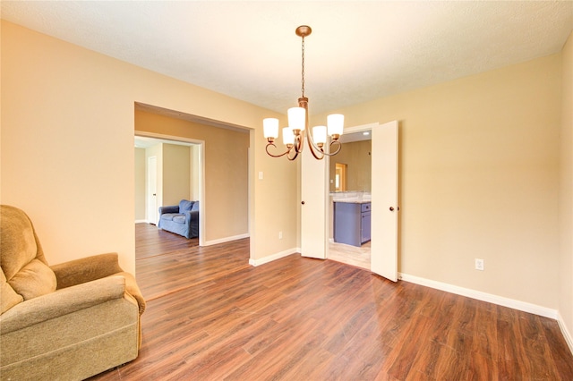 24014 Whitefield Ln, Katy, TX 77493 - interior space featuring a chandelier, wood finished floors, and baseboards