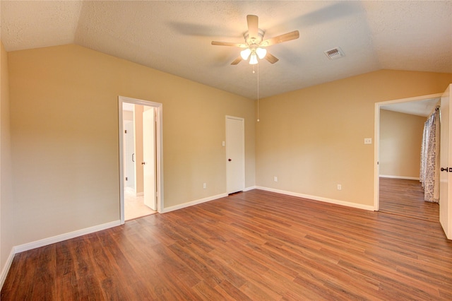 24014 Whitefield Ln, Katy, TX 77493 - spare room with vaulted ceiling, a ceiling fan, wood finished floors, a textured ceiling, and baseboards