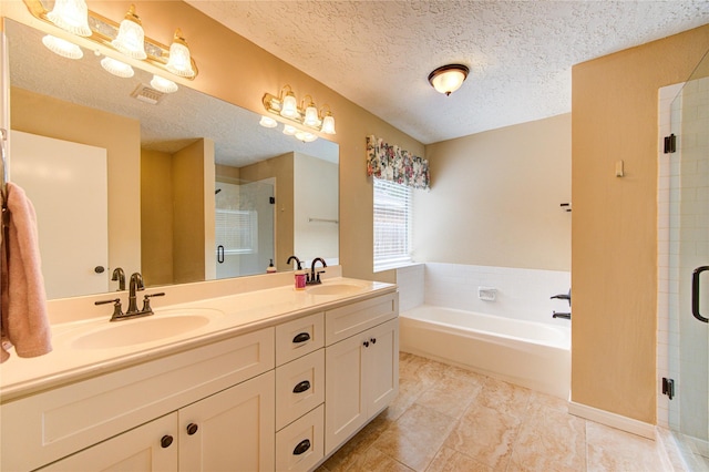 24014 Whitefield Ln, Katy, TX 77493 - bathroom with a shower stall, a garden tub, double vanity, and a textured ceiling