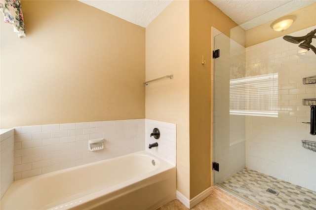 24014 Whitefield Ln, Katy, TX 77493 - full bath featuring a bath, a stall shower, and a textured ceiling