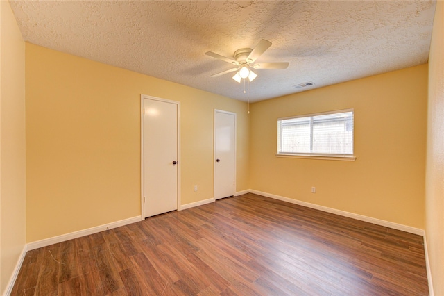 24014 Whitefield Ln, Katy, TX 77493 - unfurnished bedroom featuring wood finished floors, baseboards, a textured ceiling, and a ceiling fan