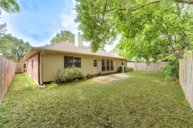 24014 Whitefield Ln, Katy, TX 77493 - back of house featuring a chimney, central AC, and a patio