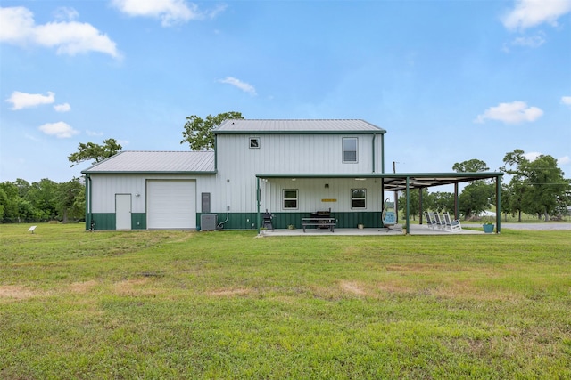 5292 Horseshoe Dr, Anderson, TX 77830 - back of house featuring a detached garage, a lawn, metal roof, and a patio area