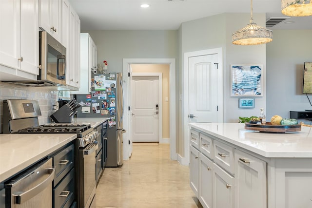 5292 Horseshoe Dr, Anderson, TX 77830 - kitchen featuring stainless steel appliances, white cabinets, decorative light fixtures, recessed lighting, and backsplash