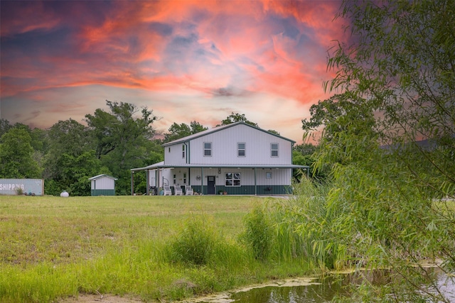 5292 Horseshoe Dr, Anderson, TX 77830 - back of property at dusk featuring covered porch