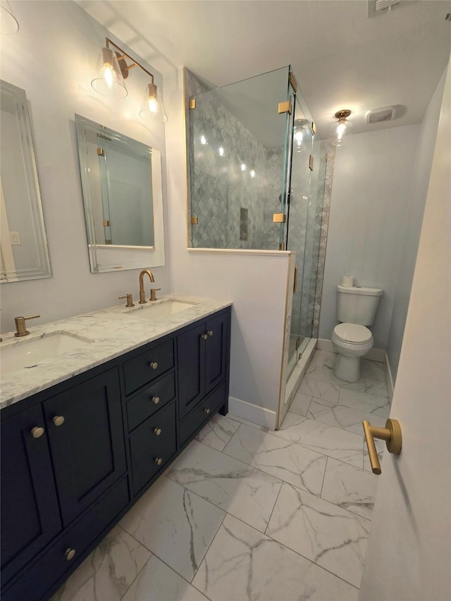 7700 Seawall Blvd Unit 409, Galveston, TX 77551 - bathroom with marble look tiles, a stall shower, toilet, double vanity, and baseboards