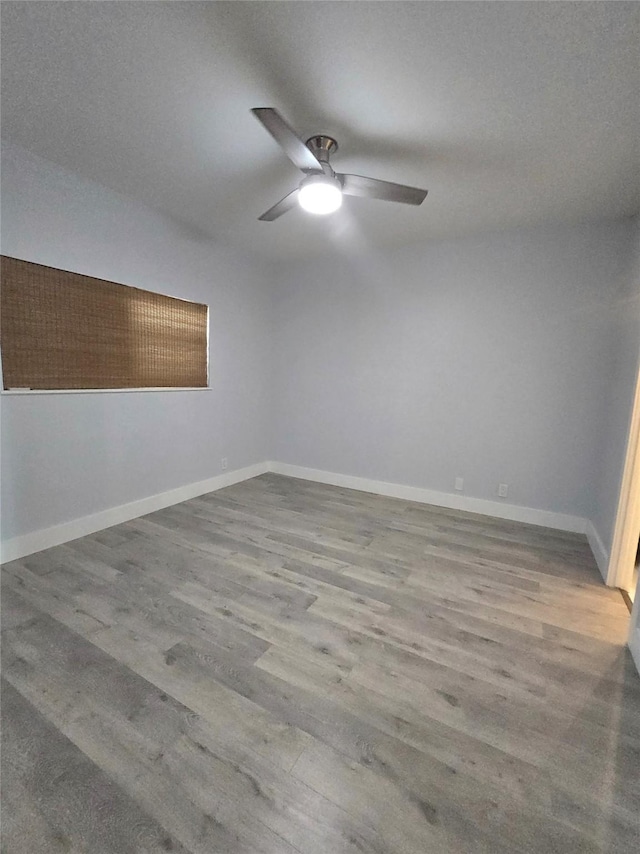 7700 Seawall Blvd Unit 409, Galveston, TX 77551 - empty room featuring ceiling fan, wood finished floors, and baseboards