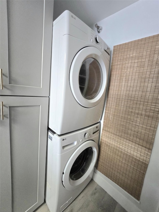 7700 Seawall Blvd Unit 409, Galveston, TX 77551 - washroom with stacked washer / drying machine and cabinet space