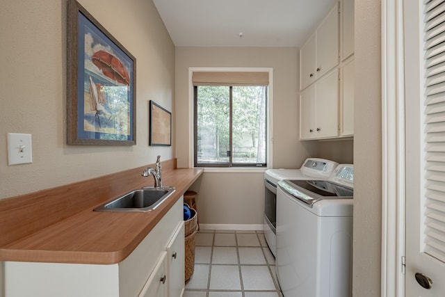 272 Boca Raton Dr, Conroe, TX 77304 - laundry area featuring cabinet space, independent washer and dryer, baseboards, and light tile patterned floors